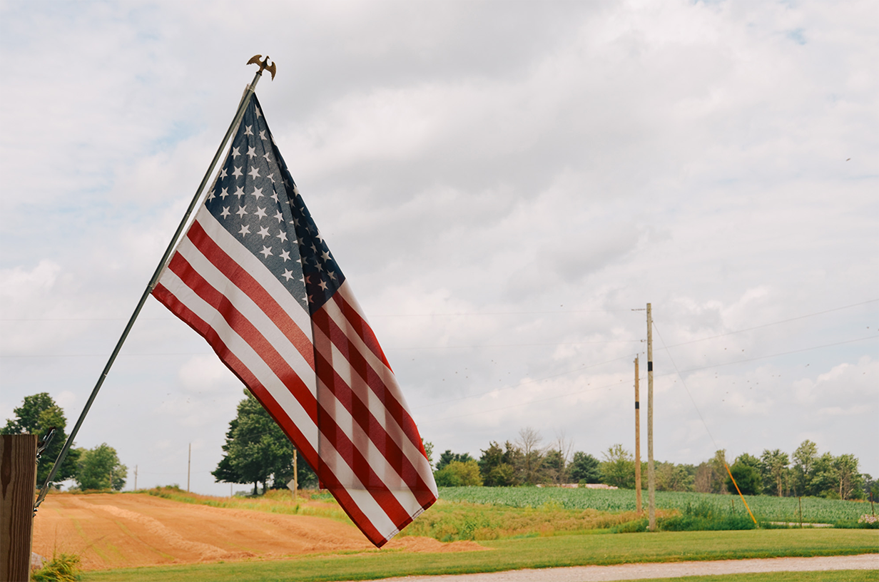 American flag in a rural setting.