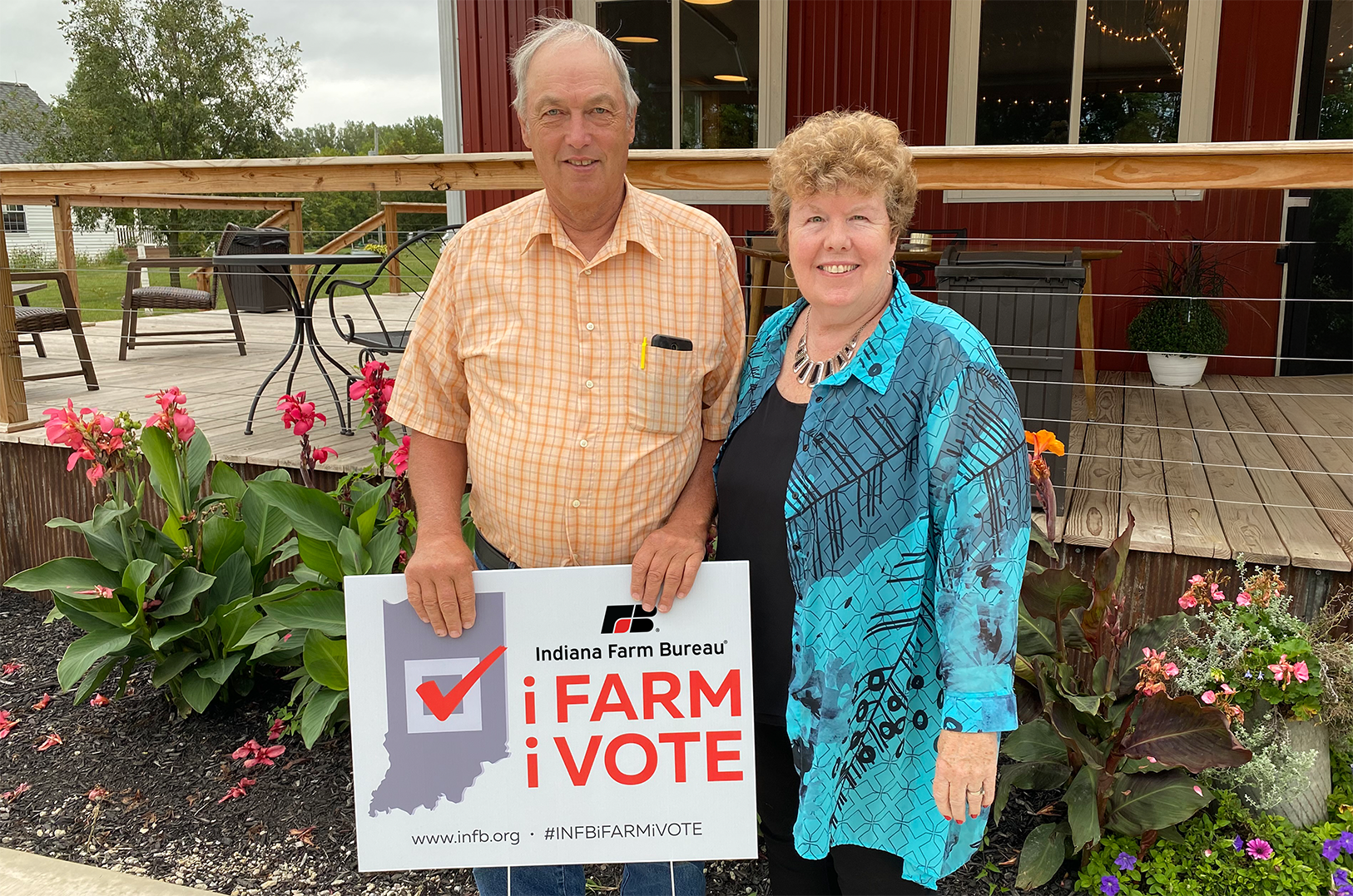 Two people holding a sign that says 