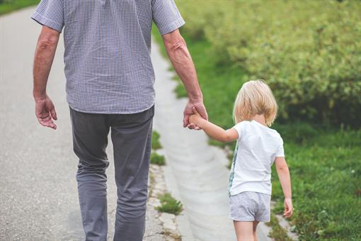 man-and-child-walking-near-bushes-during-daytime-167300